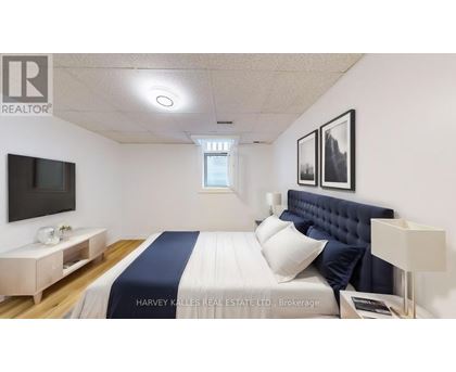 A bedroom with a bed, nightstand, and a television.