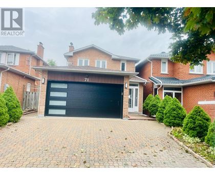 A house with a black garage door is for sale.