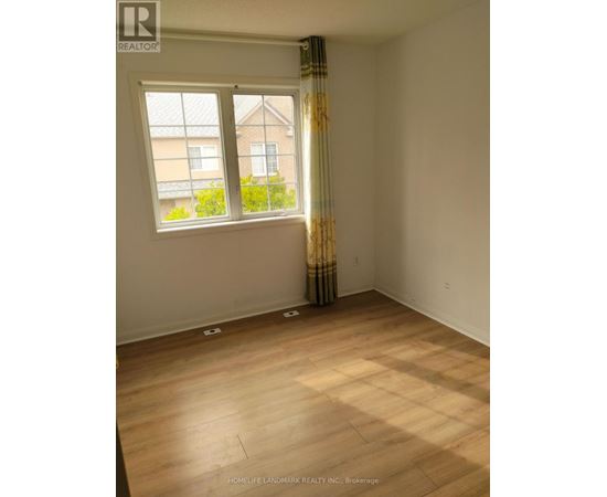 A room with a window and a curtain with a pattern on it.