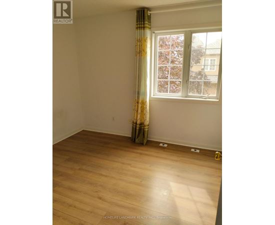 A room with a window and a curtain.
