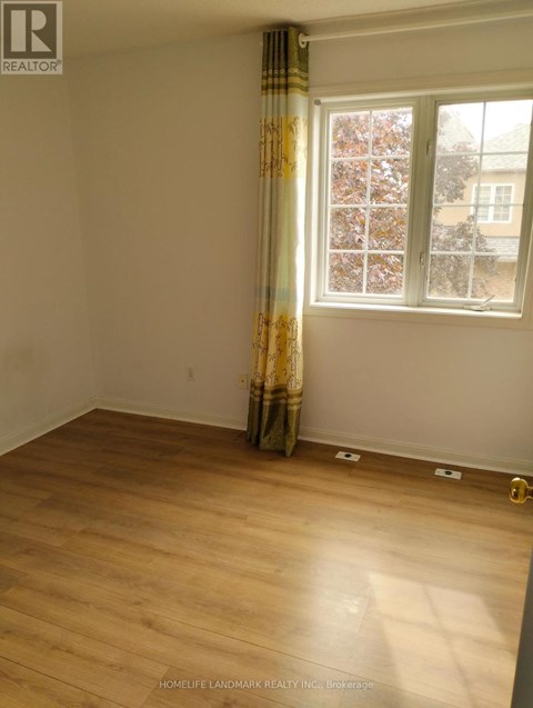 A room with a window and a curtain.