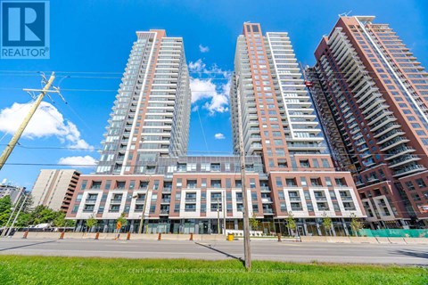 A large building complex with multiple high-rise buildings and a clear blue sky above.