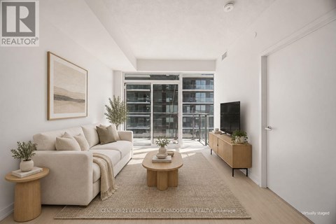 A living room with a large window and a flat screen TV.