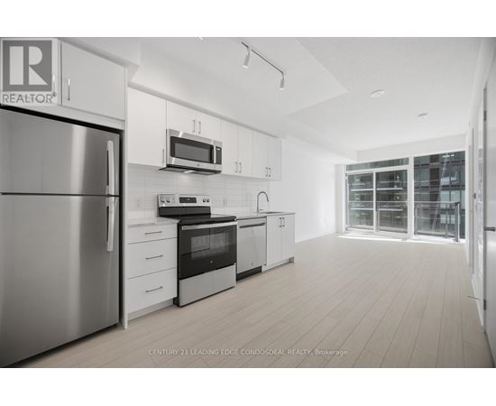 A modern kitchen with white cabinets and stainless steel appliances.