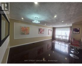 A room with a ceiling light and a painting on the wall.
