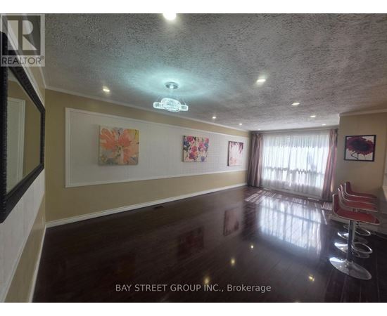 A room with a ceiling light and a painting on the wall.