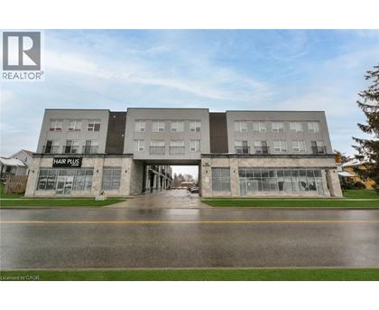A building with the sign Hair Plis on the ground floor.