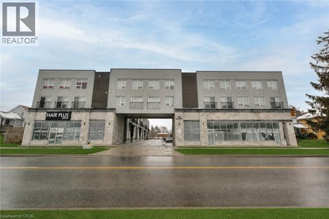 A building with the sign Hair Plis on the ground floor.