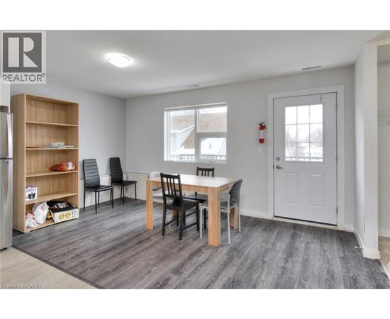A dining room with a table and chairs.