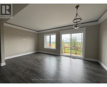A spacious room with a sliding glass door leading to a balcony.
