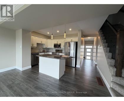 A spacious kitchen with a stainless steel refrigerator and a modern design.
