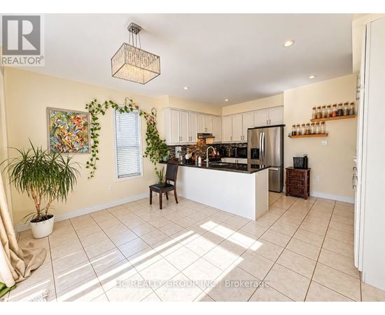 A kitchen with a white counter and a plant in a white pot.