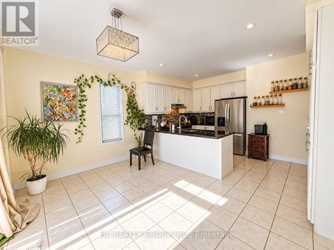 A kitchen with a white counter and a plant in a white pot.