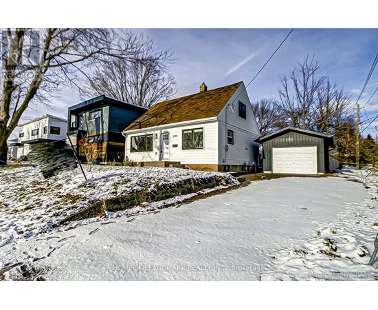 A house with a garage is surrounded by snow.