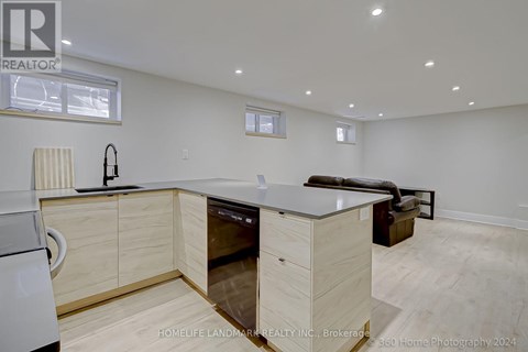 A modern kitchen with wooden cabinets and a dishwasher.