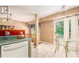 A kitchen with a white dishwasher and a green counter.