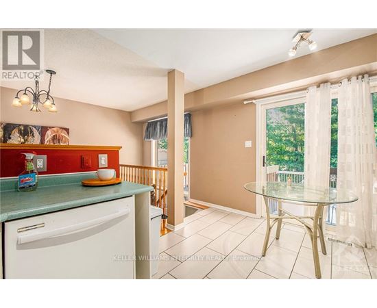 A kitchen with a white dishwasher and a green counter.