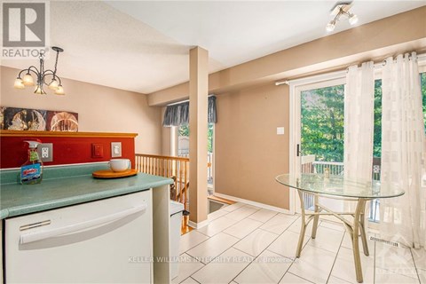 A kitchen with a white dishwasher and a green counter.