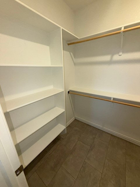 Empty white shelves in a room.