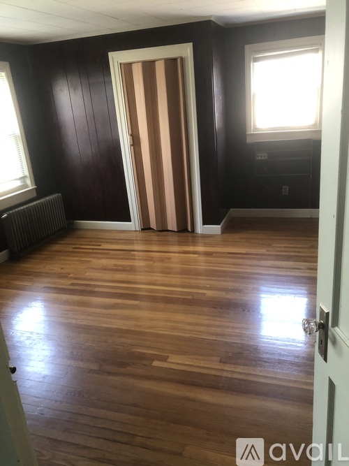 A room with wooden floors and a white door.