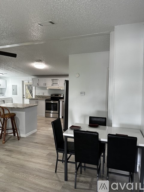 A kitchen with a bar area and chairs.