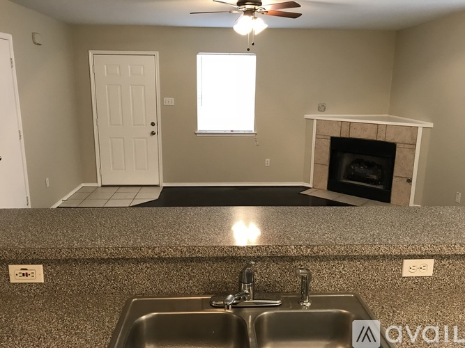A kitchen with a sink and a fireplace.