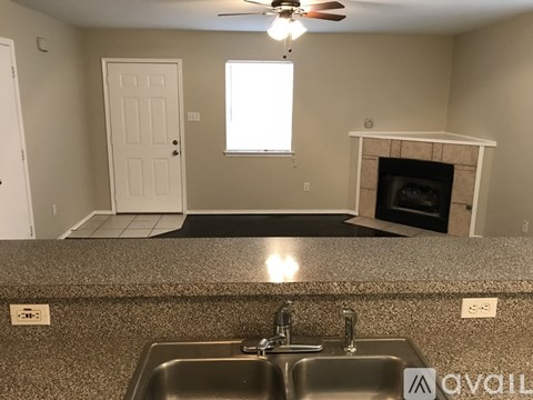 A kitchen with a sink and a fireplace.