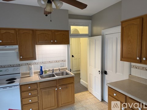 A kitchen with wooden cabinets and a white oven.