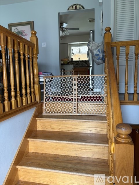 A wooden staircase with a metal railing.