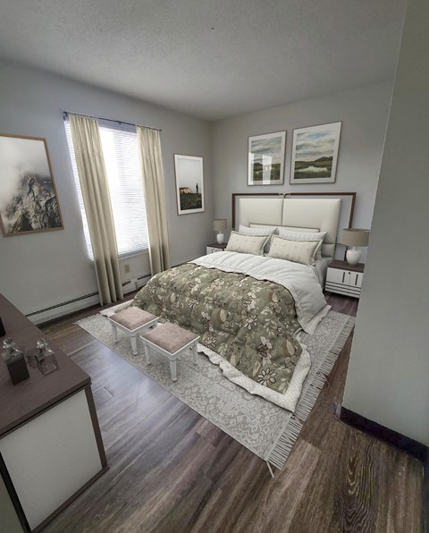 A bedroom with a large bed and a wooden floor.