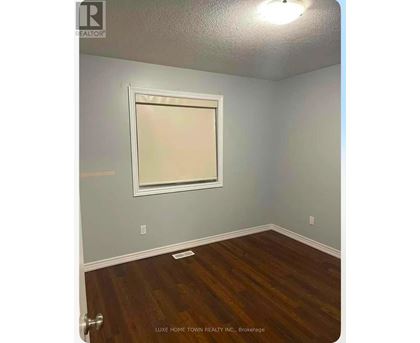A room with a wooden floor and a window.