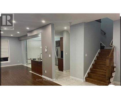 A spacious room with a staircase leading to the upper floor.
