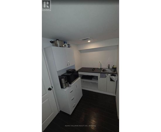 A small kitchen with white cabinets and a sink.