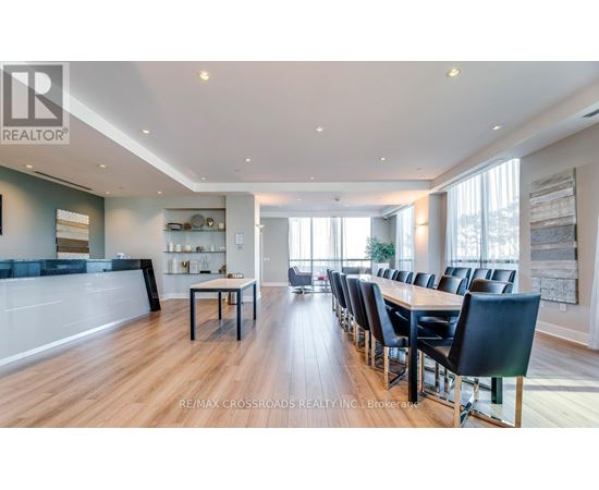 A modern dining room with a long table and chairs.