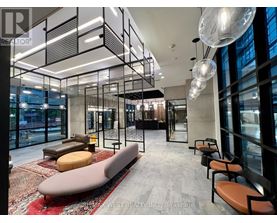 A modern office space with a glass wall and a long bench.