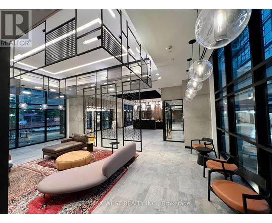 A modern office space with a glass wall and a long bench.
