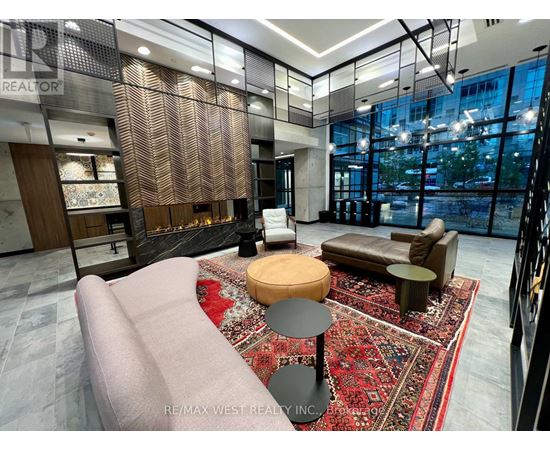 A modern living room with a large sofa and a rug.