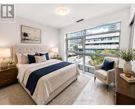 A bedroom with a large bed and a view of a cityscape through the window.