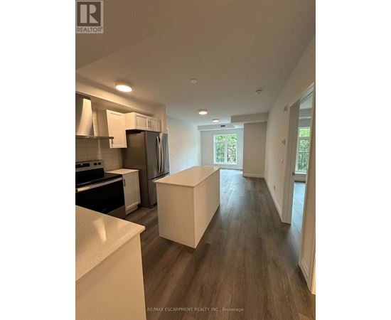 A kitchen with white countertops and a white island in the middle of the room.