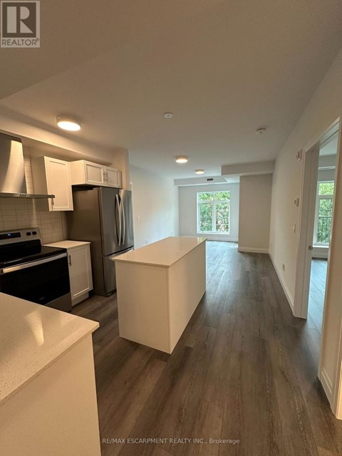A kitchen with white countertops and a white island in the middle of the room.