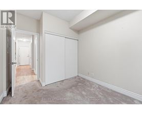 A realtor photo of a white bedroom with a carpeted floor.