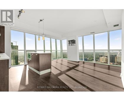 A spacious room with large windows overlooking a cityscape.