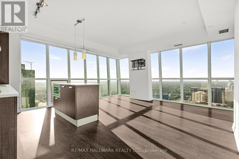 A spacious room with large windows overlooking a cityscape.