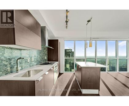 A modern kitchen with a large window overlooking the city.