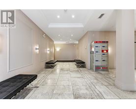 A hallway with a bench and a vending machine.