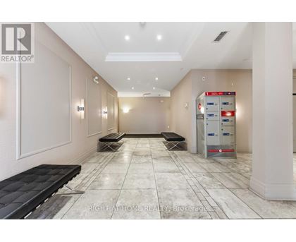 A hallway with a bench and a vending machine.