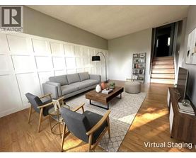 A living room with a grey couch, a coffee table, and a television.