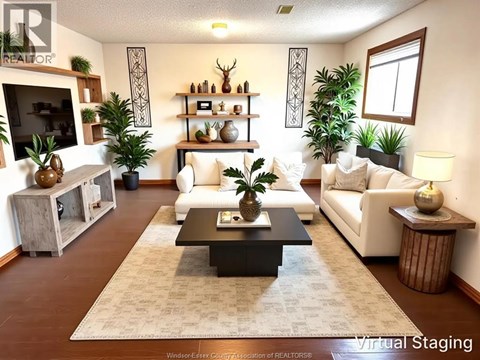 A living room with a white couch and a coffee table in the center.