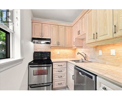 A kitchen with wooden cabinets and stainless steel appliances.