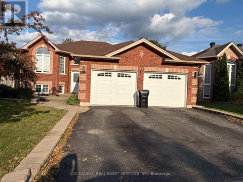 A house with a brick facade and two garages.